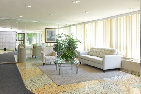 a living room with white couches and chairs and a table